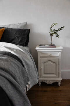 Cute vintage bedside table and greenery