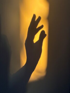 the shadow of a hand n the wall