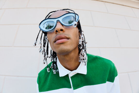 Stylish Portrait with Beaded Braids and Bold Sunglasses