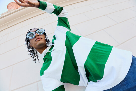 Upward Gesture in Bold Streetwear