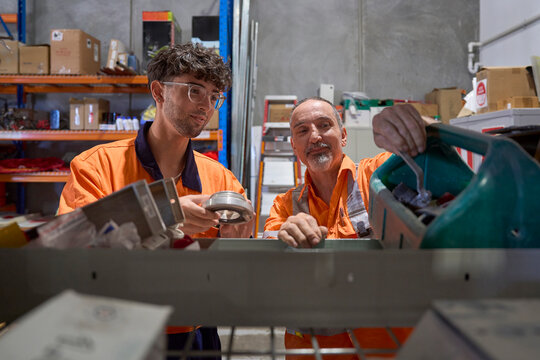 Apprentice collaborating in a tool and hardware warehouse setting
