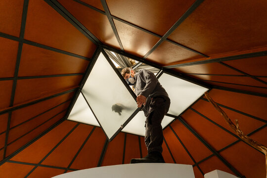 Worker repairing skylight