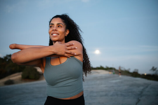 Woman Exercising Outdoors at Sunset Demonstrating Positivity