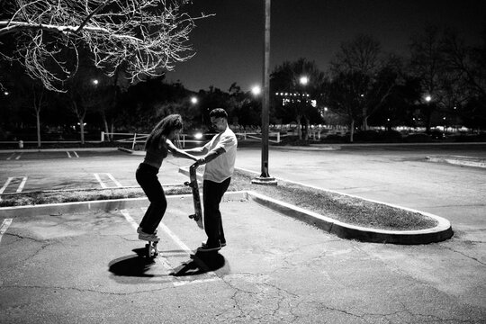 Skateboarding Practice in Empty Parking Lot at Nighttime