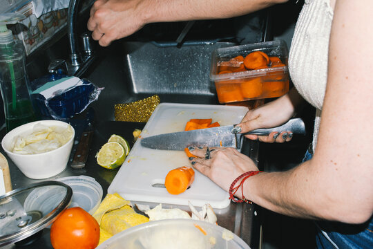Woman's hands sliding a carrots