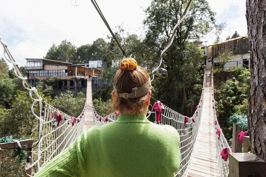 Back View of Woman on Suspension Bridge in Mexico