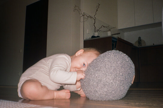 Cute Baby Playing with Soft Pillow  - film analog