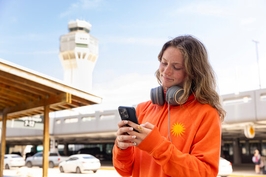 Teen Using cell phone travel airport 