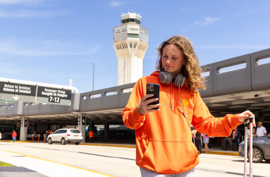 Teen Using cell phone travel airport tower 