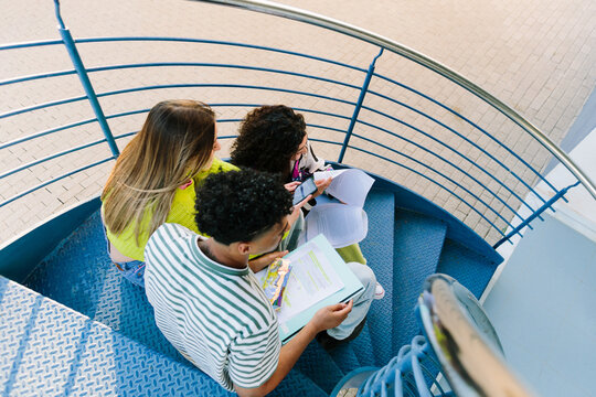 studying on blue stairs