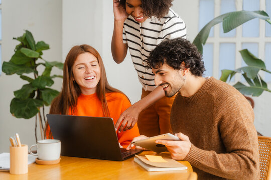 Smiling Teamwork Collaborating On Project In Modern Office