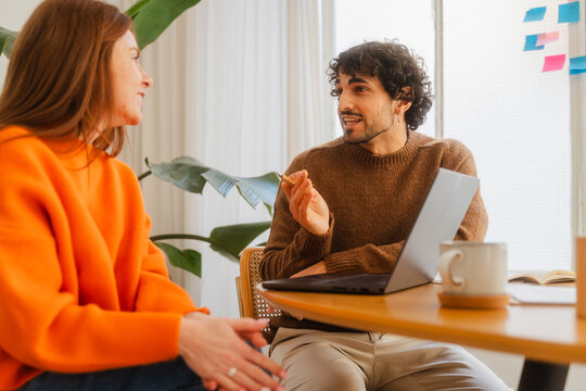 Colleagues Discussing During Business Meeting At Modern Office