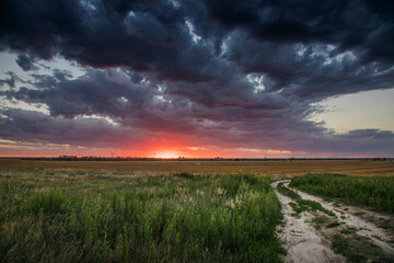 Moody Sunset with Storm Clouds over Open Plains