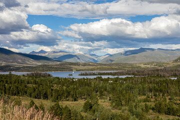 Summer Lake and Forest Background with Mountain Clouds