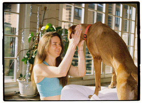 Woman interacting happily with her dog indoors