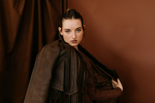 Model touching  her brown leather 