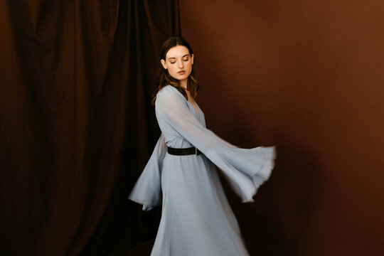 Blurry model with dress moving arms