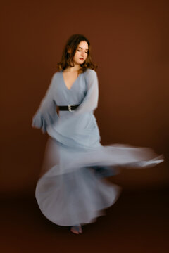 Blurry dancer  dancing on brown background