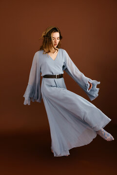 Woman dancing wearing long light blue dress