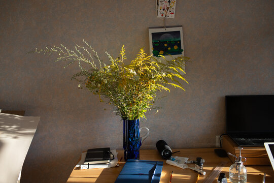a vase of wildflowers on the table in the room