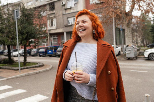 Trendy Redhead Enjoying a Casual Day Out in an Urban Neighborhood