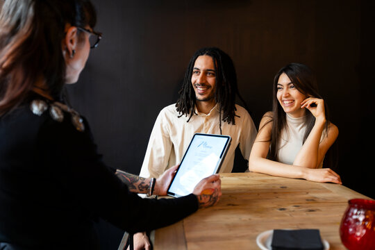 Couple doing menu testing with wedding planner 