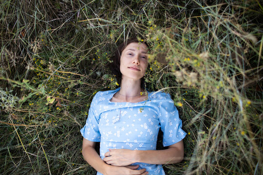 a woman is lying on the grass