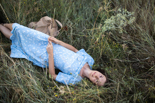 a woman is lying on the grass