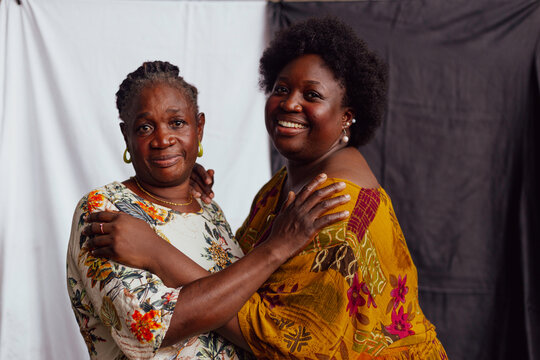 Mother and daughter holding each other's shoulders