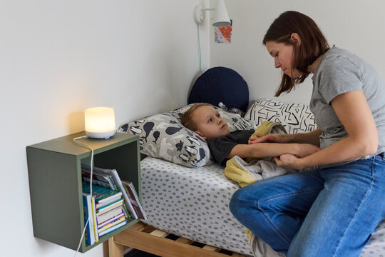 Mom applying eczema cream on her son