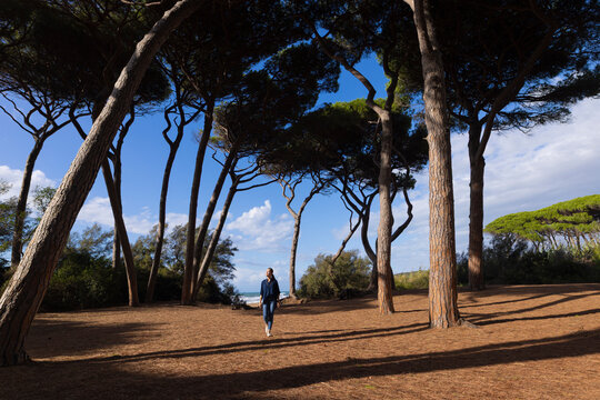 asian woman under pine trees