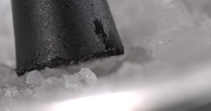 Super slow motion, Closeup Reveals Small Ice Fragments Ejecting When Tool Presses Against Crystalline Surface