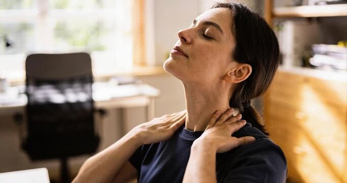 Woman stretching neck indoors relieving pain day sunlight