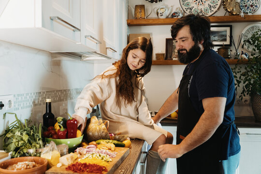 Father And Daughter In The Kitchen Preparing Lunch
