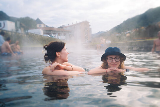 Friends relaxing in a steaming hot spring