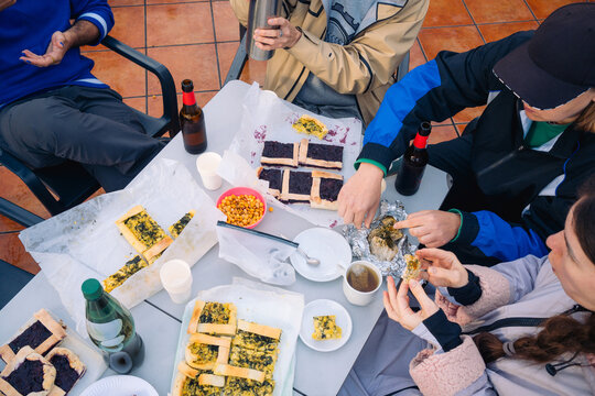 Group of friends enjoying homemade food at an outdoor gathering