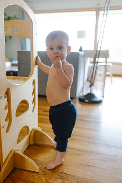Toddler Standing and Snacking at Home