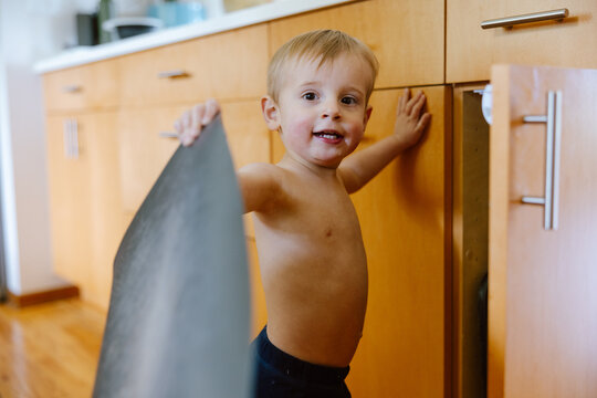 Smiling Toddler Playing in Kitchen