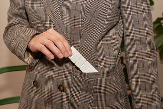 Person placing pill organizer in a pocket
