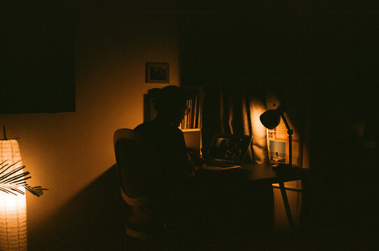Unknown person at her desk at night