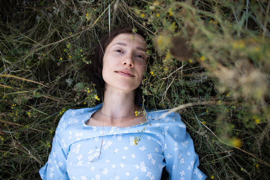 a woman is lying on the grass