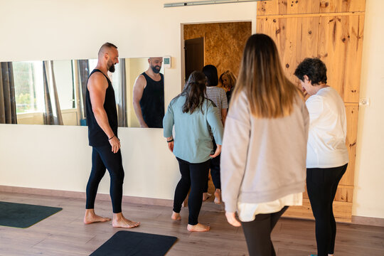 Yoga instructor guiding group therapy and relaxation class