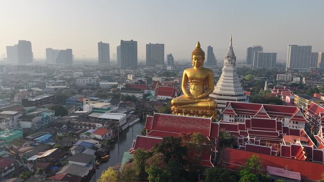 Golden buddha statue at wat paknam phasi charoen sunset sky with rivaer aerial view sightseeing travel in Bangkok Thailand 