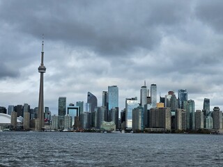 Fototapeta premium Toronto Ontario Canada - CN Tower skyline under dramatic storm clouds over Lake Ontario