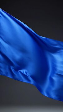 Vibrant Blue Fabric Billowing Gracefully With Subtle Folds And Shadows Against A Dark Backdrop