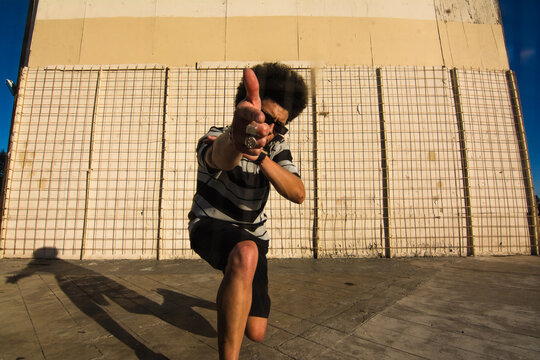 Man dancing and pointing at camera