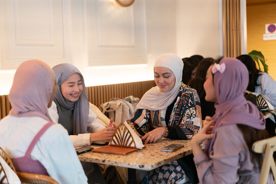 Hijabi Muslim Women Having Coffee
