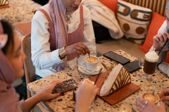 Hijabi Muslim Women Having Coffee