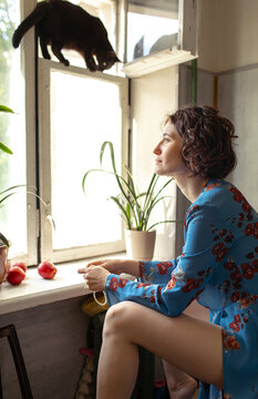 Brunette woman sitting by the window