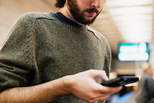 Young man using cell phone in Chicago subway station